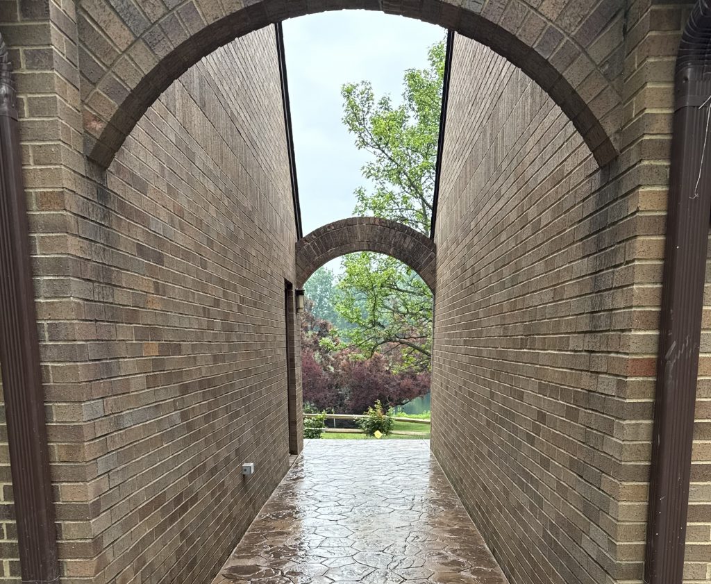 Brick archway passage with matching brick walls and an arched opening