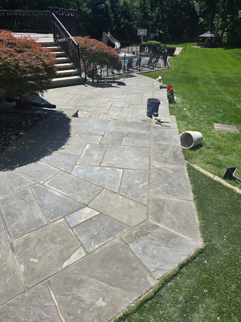 Natural flagstone walkway installed through a residential lawn
